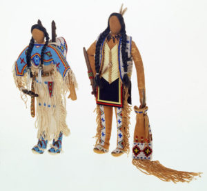 Two dolls wearing traditional garb
