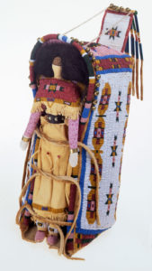 Native American doll in a beaded carrier