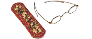 Colorful case and pair of gold colored glasses