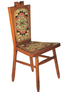 Wooden chair with ornate seat and back covers